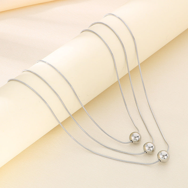 Cold wind high-grade titanium steel three-layer stacking wearing wind comes and goes round beads pearl titanium steel snake bone chain necklace necklace item decoration